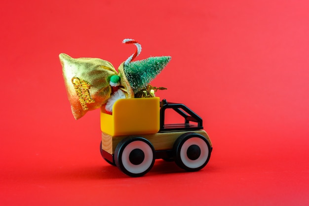 A toy truck carries a bag of gifts for Christmas.