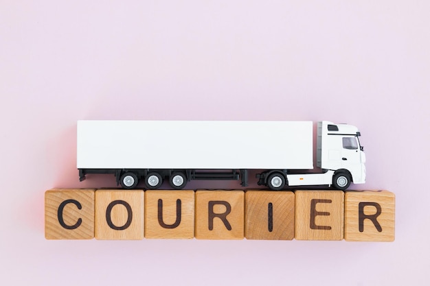 Toy truck with wooden box on purple background Courier