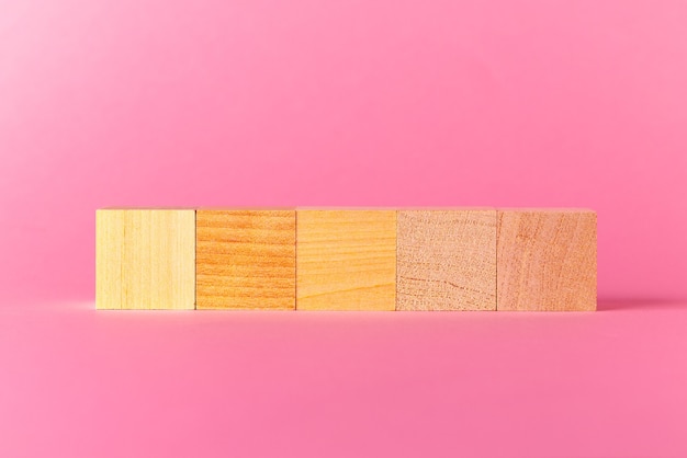 Toy wooden cubes with copy space against pink