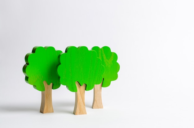 toy wooden figures of trees on a white background