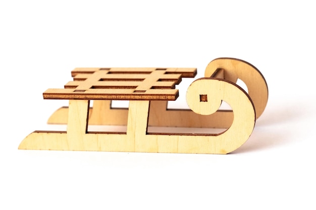 Toy wooden sled on white isolated background