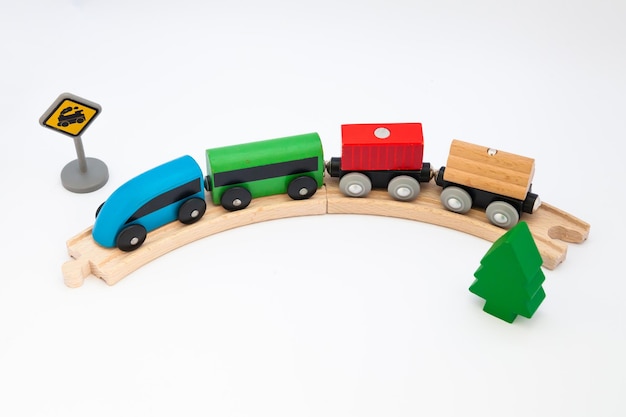 Toy wooden steam locomotive transports goods by rail