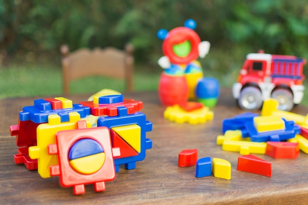 木製のテーブルのカラフルなプラスチックブロックで作られたおもちゃ