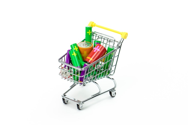 Toys trolley from supermarket full of colorful batteries isolated on white