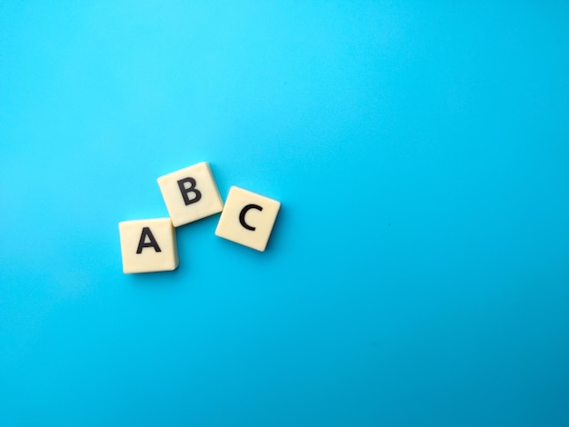 Toys word with word ABC on blue background Education concept