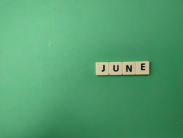 Photo toys word with the word june on a green background