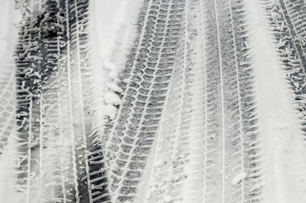 Traces of car wheels on a snowy road