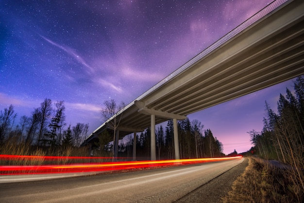 Photo traces of the headlights on the road in the night