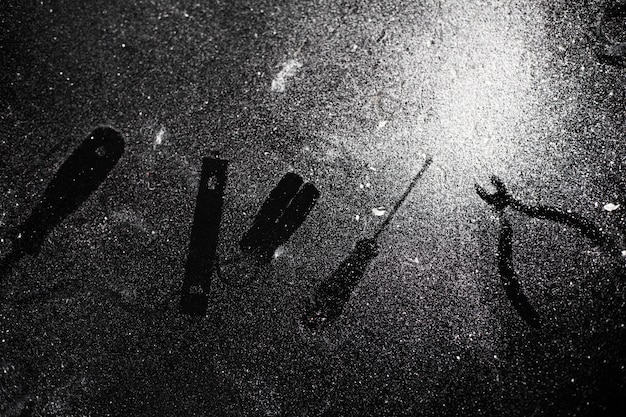 Traces of tools on black table dusted with white dust