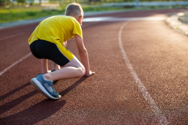 track and field athletes training at the stadium