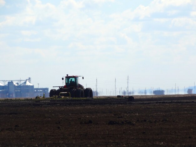 Tractor cultivating field at springspring works