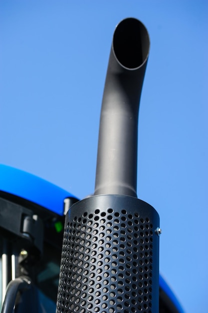 Tractor exhaust pipe blue sky background