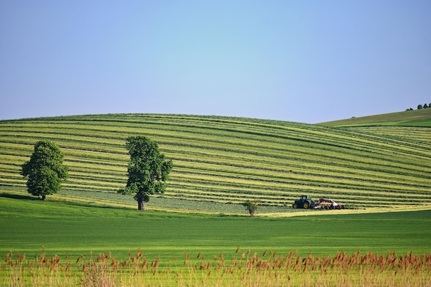 Tractor in the field Beautiful spring landscape in the countryside in the Czech Republic Concept for agriculture and nature