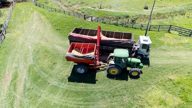 Tractor harvesting soybeans on a farm in Brazil Dumping into another tractor