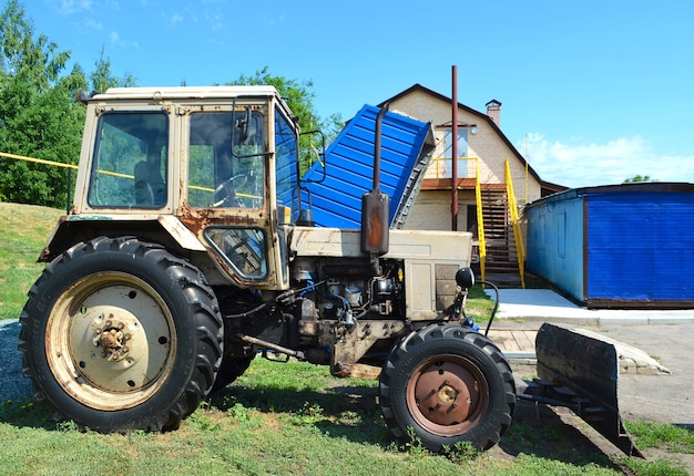 Tractor outdoors on green grass in sunny day