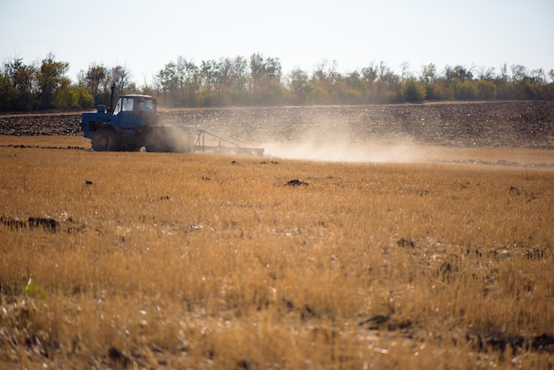 Tractor plowing fields -preparing land for sowing