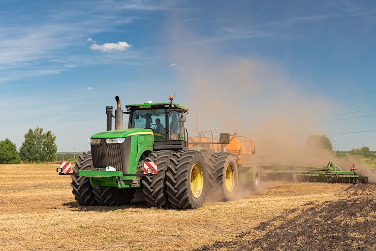 Photo the tractor plows the land. agriculture image