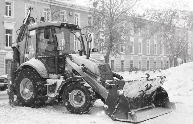 Tractor for snow removal is parked on a city street after work