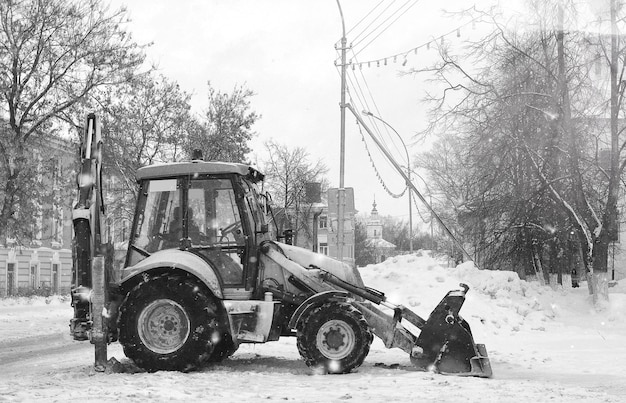 Tractor for snow removal is parked on a city street after work