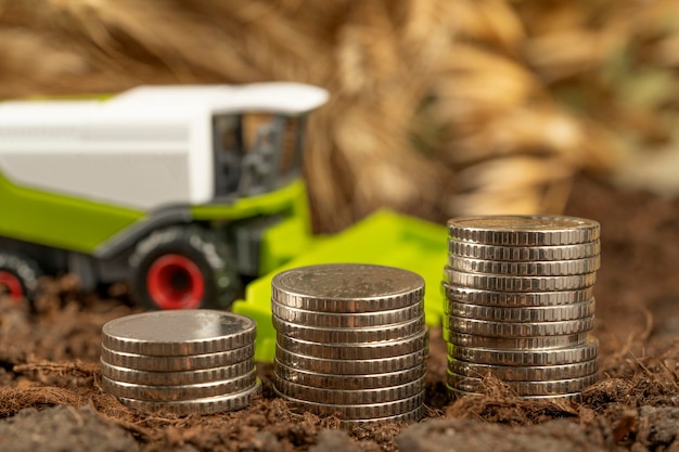 Трактор с деньгами на фоне колосков пшеницы Экспорт зерна и сельского хозяйства Рост цен на сельхозпродукцию