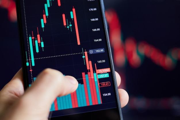 Trader analyzes stock market data in smartphone