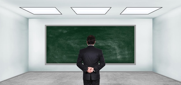 Trader looking on blank blackboard