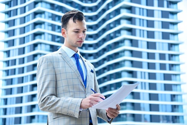 Trader man holding business stock data in hands finance and business concept close up