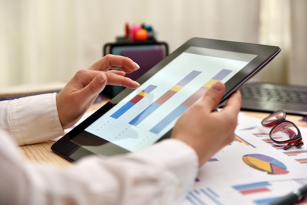 Trader woman touching tablet with graph