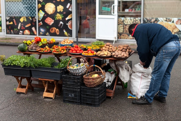 Photo trading seasonal goods at the street market the farmer puts the goods on the counter