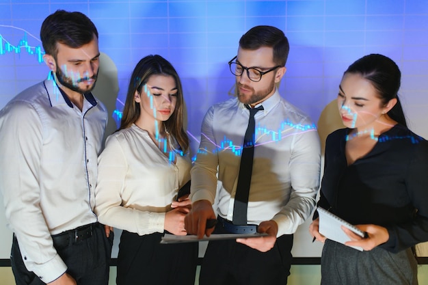 Trading teaching Male leader talking to employees showing the plan on the projector in office of stock exchange company