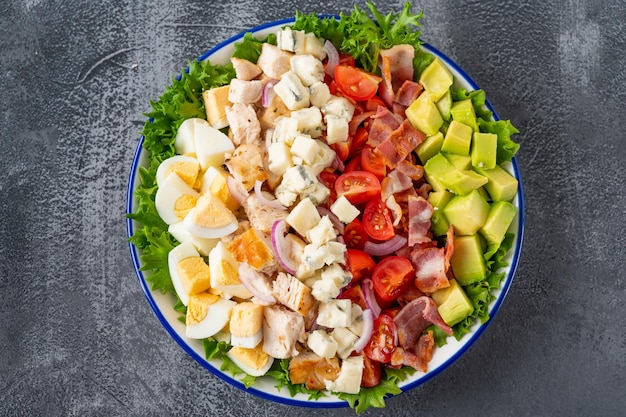 Tradition Cobb salad with fried chicken avocado fresh tomatoes eggs bacon and cheese