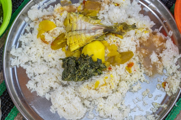 Traditional african food is fried fish along with potatoes and
white rice on the zanzibar island tanzania africa close up