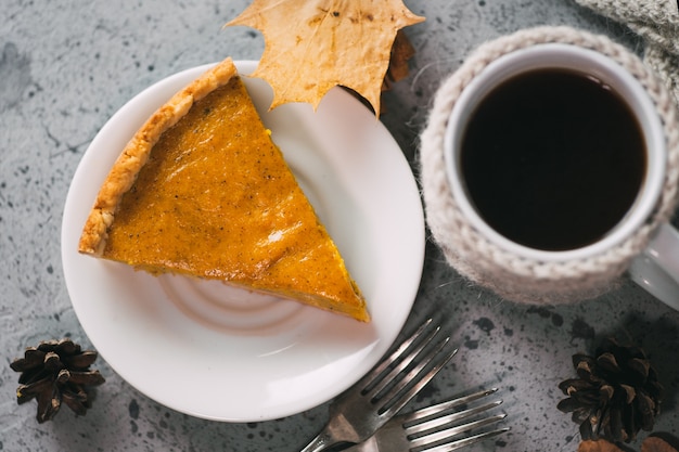 Traditional American thanksgiving pumpkin pie and coffee mug