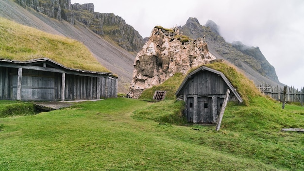 Traditional antique Viking village. Old wooden houses near Vestrahorn mountains on the Stokksnes Peninsula, Hofn, Iceland. Popular tourist attraction.