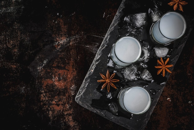 Traditional arabic alcohol drink Raki with anise, dark rusty surface copy space top view