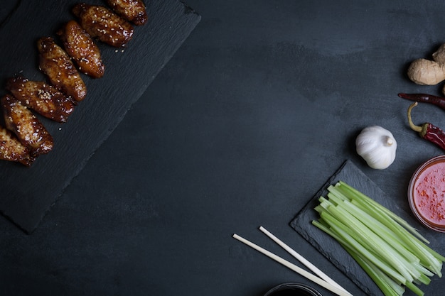 Traditional Asian stir fry chicken wings with sesame and vegetables