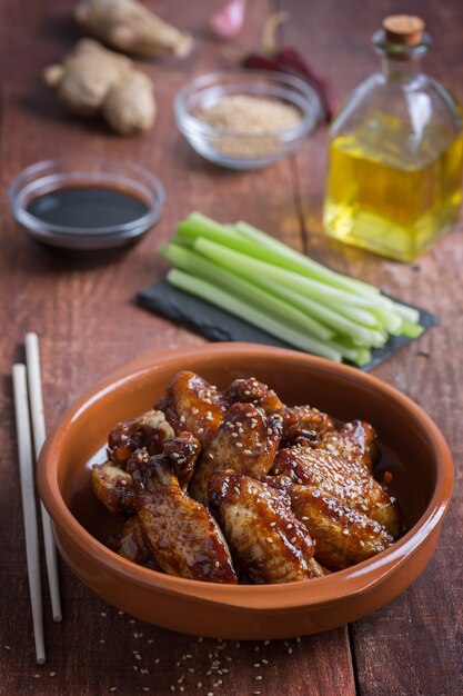 Traditional Asian stir fry chicken wings with sesame and vegetables