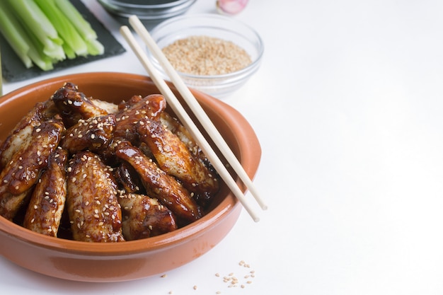 Traditional Asian stir fry chicken wings with sesame and vegetables