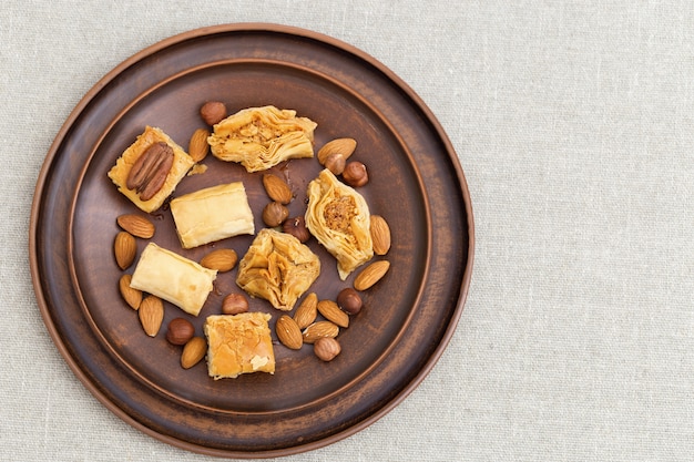 Traditional assortment of oriental sweets with chopped nuts and honey. 