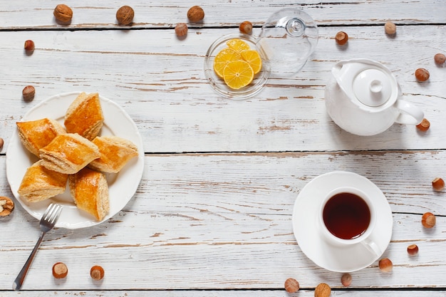 Traditional Azerbaijan holiday Novruz cookies baklava on white plate on the white background with nuts and shakarbura