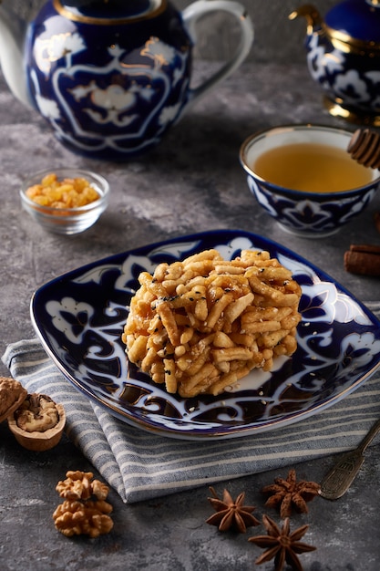 Traditional azian cake chuk chuk with honey and nuts vertical