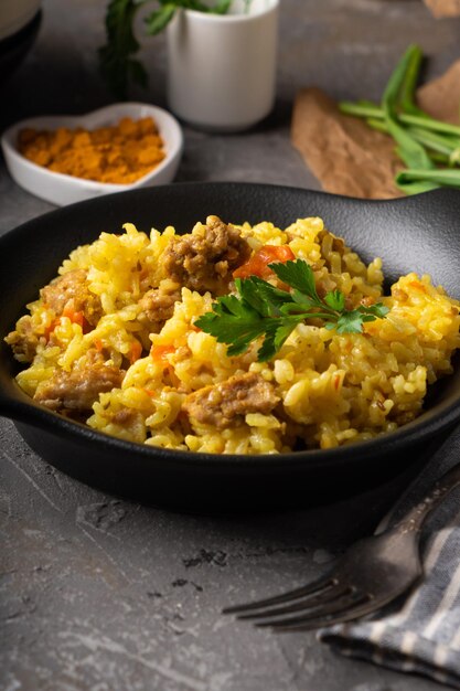 Traditional azian pilaf served in plate on gray background