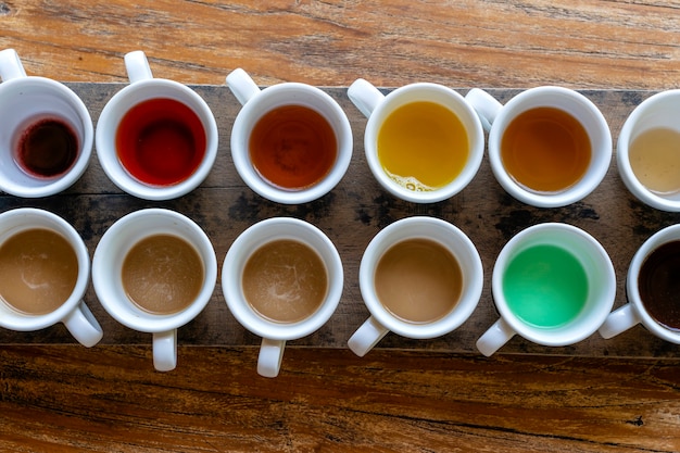 Traditional Balinese coffee and tea after testing on the wooden table in Ubud, island Bali, Indonesia , close up