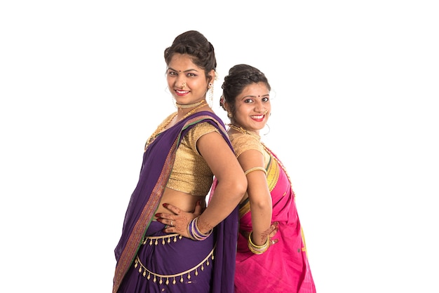 Traditional Beautiful Indian young girls in saree posing on white