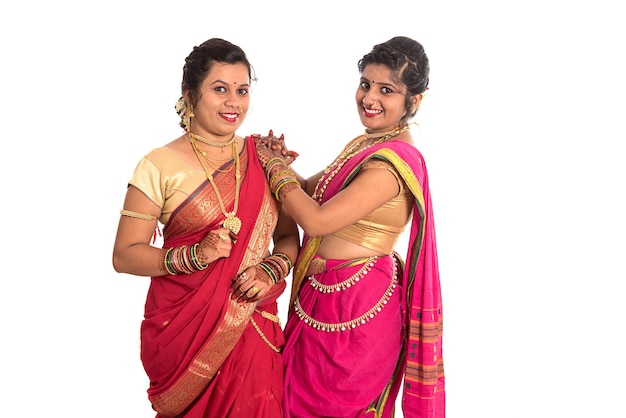 Traditional Beautiful Indian young girls in saree posing on white