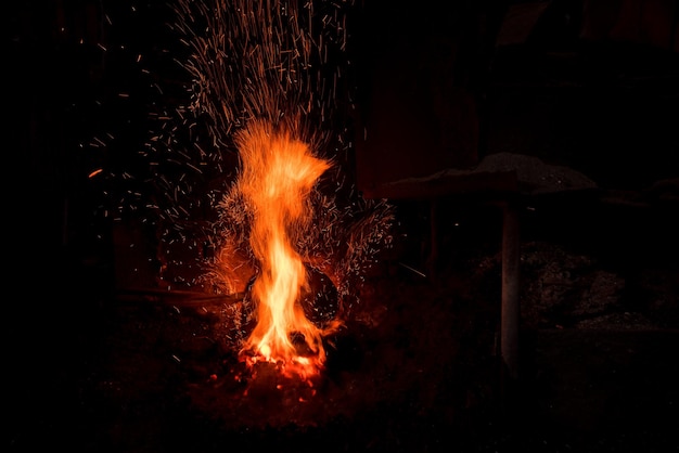 Traditional blacksmith furnace with burning fire
Burning fire in furnace at forge, workshop. Blacksmith equipment concept