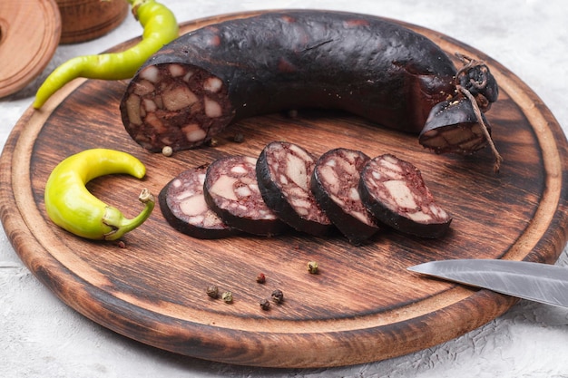 Traditional blood sausage cut into wedges on a wooden board