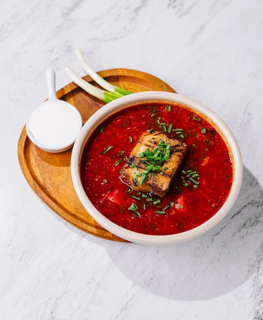 Traditional borscht soup with pork and herbs