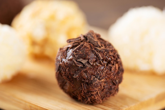 Traditional brazilian brigadeiro sweets with chocolate coconut\
and cashew nuts homemade closeup