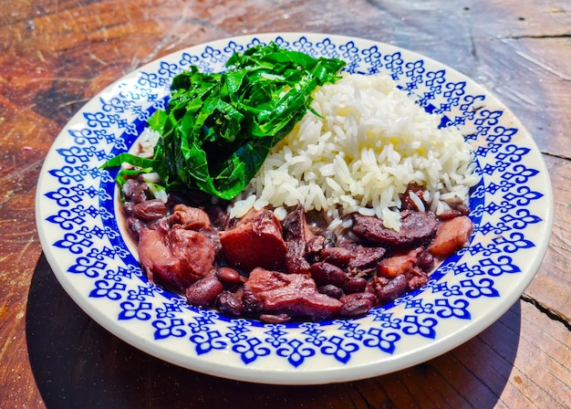Traditional Brazilian feijoada with cabbage and rice